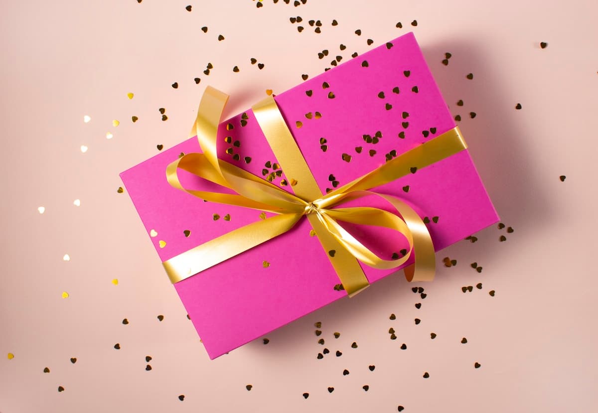 Hands carefully wrapping a gift box